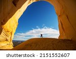 Hiker in the Great Chamber grotto, Utah, USA. Travel and journey scene.