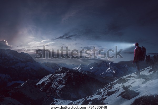 Hiker with headlamp on a\
mountain