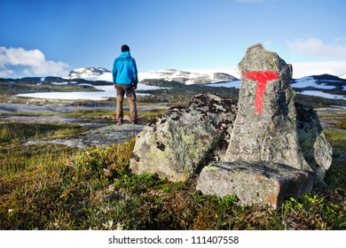 Hiker With Hiking Signs In Norway - Hardangervidda