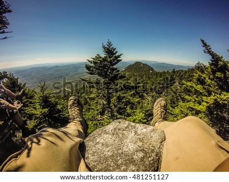 Hiker legs and boots view on the mountain peak relaxing outdoor mountain sport Stock fotó © 