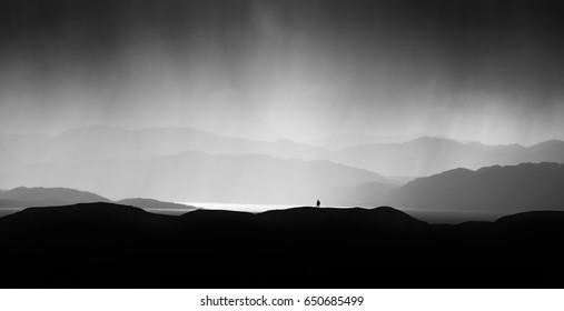 A Hiker Looking Out Across Loch Ewe In The Scottish Highlands As Heavy Rain Approaches.  Scotland, UK.                               