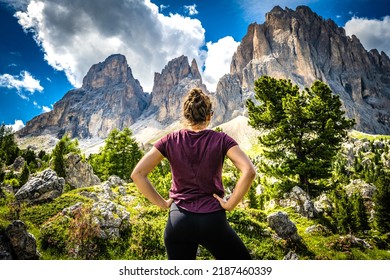 Hiker looks at Sassolungo in the Dolomites