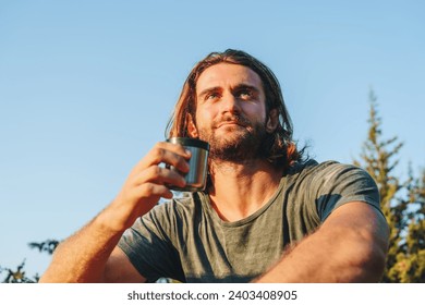 Hiker man with backpack holding thermos in his hand - Powered by Shutterstock