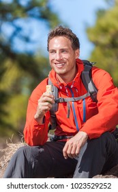 Hiker Man Healthy Outdoor Lifestyle Eating Muesli Bar During Hike On Mountain Hiking. Happy People Eat Granola Cereal Bar Snack Living Active Lifestyle In Nature.