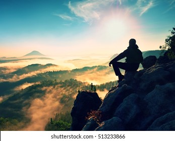 Hiker man take a rest on mountain peak. Man lay on summit, bellow autumn valley. Bright morning Sun shining in sky.  - Powered by Shutterstock