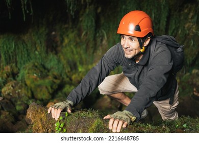 Hiker man wearing a helmet inside a cavern - Powered by Shutterstock