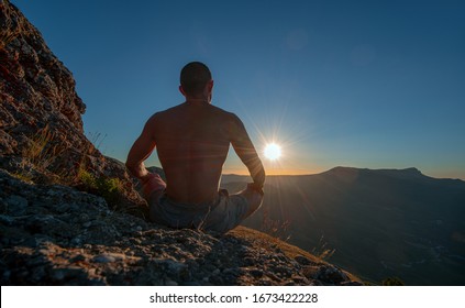 hiker meditate in lotus pose, on beauty mountain landscape background, holiday traveling concept, horizontal photo