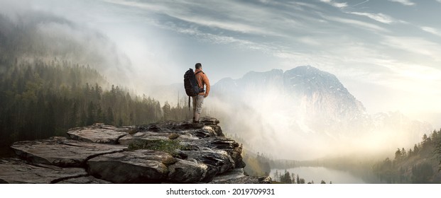 Hiker in mountain landscape enjoys sunrise - Shutterstock ID 2019709931