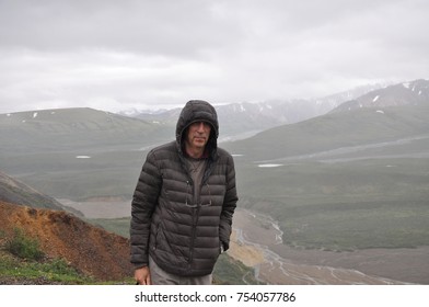 Hiker At Mountain Top With Direct View Of The Denali Mountain