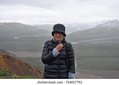 Hiker At Mountain Top With Direct View Of The Denali Mountain