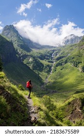 hiker observing the top, Ascending towards Hourgade Peak, Pyrenean mountain range, France - Shutterstock ID 2183675589