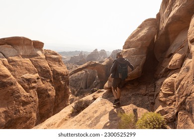 Hiker on Cliff at Arches National Park