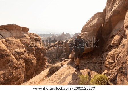Hiker on Cliff at Arches National Park