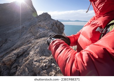 Hiker on high altitude mountain top checking the altimeter on the sports watch - Powered by Shutterstock