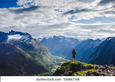 Hiker on the mountain top. Sport and active life concept. Hiking ROMSDALSEGGEN RIDGE, Andalsnes City, Norway