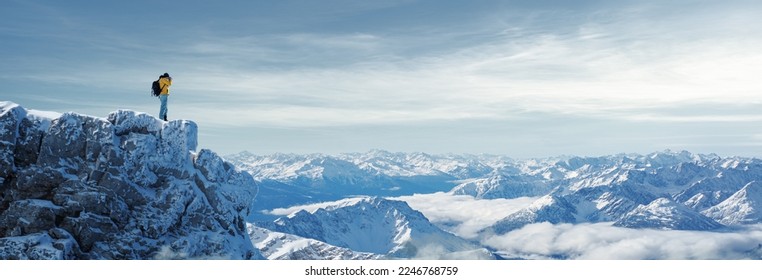 Hiker photographer in snowy mountains - Shutterstock ID 2246768759