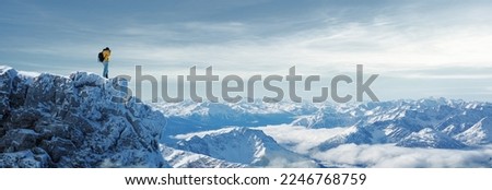 Hiker photographer in snowy mountains