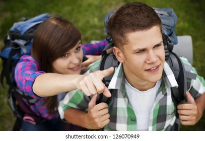 Hiker Pointing At Something In Forest