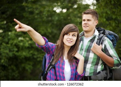 Hiker Pointing At Something In Forest