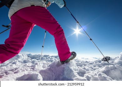 Hiker Posing At Top Of Snowy Mountain During Sunny Day