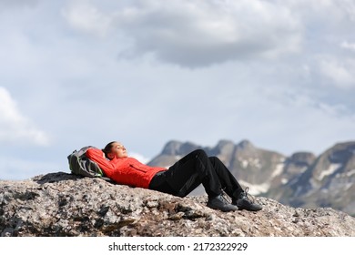 Hiker in red resting in a high mountain top after climbing - Powered by Shutterstock