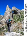 A hiker staring up at Lexington Arch in Great Basin National Park. 