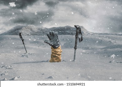 Hiker stretching out his snow covered hand next to trekking poles to signal help because of snow avalanche . Danger extreme concept - Shutterstock ID 1510694921