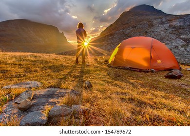 Hiker in the Sunrise with Tent