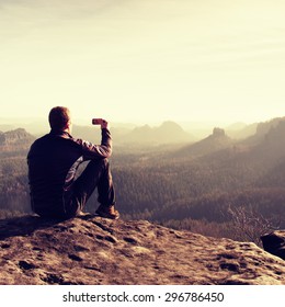 Hiker Is Taking Photo By Smart Phone On The Peak Of Mountain  At Sunrise.