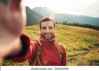 Hiker taking a selfie while out trekking in the wilderness - Powered by Shutterstock