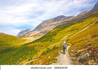 Hiker Trekking On The Highline Trail In Glacier National Park In Montana In The Fall