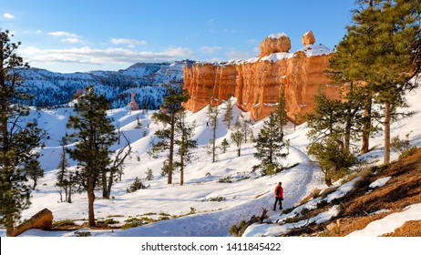 A hiker ventures along the snowy trails of Utah's Bryce Canyon National Park in winter. - Powered by Shutterstock