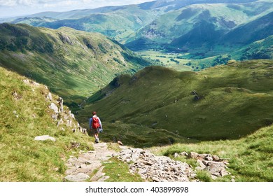 A Hiker Walking In The English Lake District, UK.