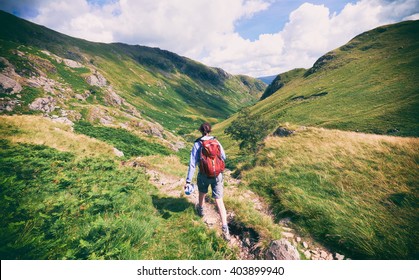 A Hiker Walking In The English Lake District, UK.