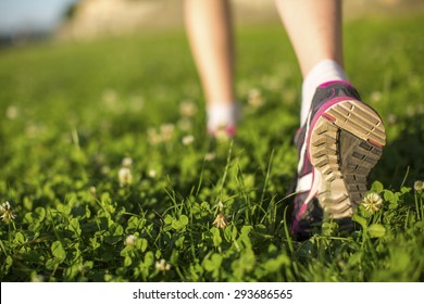 Hiker Walking In The Green Grass Outdoors, Low Angle Close Up Of The Foot.