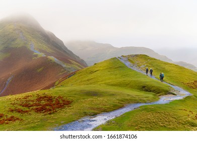 Hiker Walking On Top Of Cat Bells In Lake District, United Kingdom 