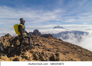 Hiker watches Volcano Popocatepetl erupt trekking in at the top Iztaccihuatl volcano, Mexico, Iztaccihuatl Popocatepetl National Park