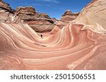 Hiker in The Wave, Coyote Butte North, Vermillion Cliffs Wilderness, Arizona, USA