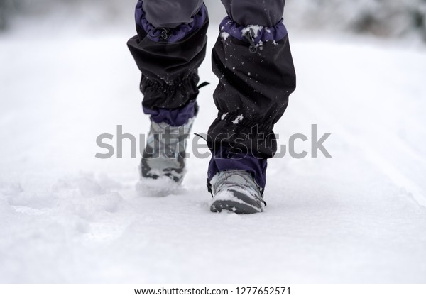 Hiker wearing a snow boots and gaiter at snowy\
winter country