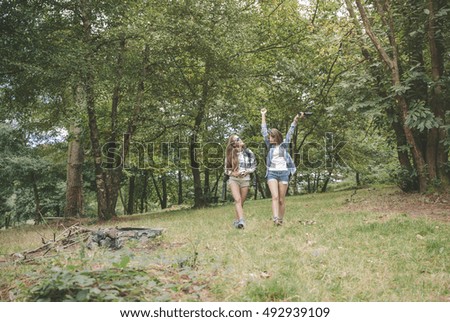 Similar – Women friends laughing while walking in forest