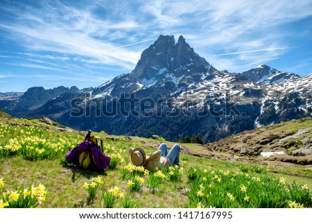 an hiker woman resting and looking the Pic du Midi Ossau in the french Pyrenees mountains