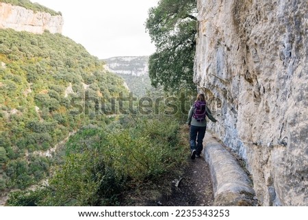 Hiker woman walking along a precipice.