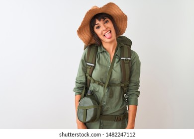 Hiker Woman Wearing Backpack Hat And Water Canteen Over Isolated White Background Sticking Tongue Out Happy With Funny Expression. Emotion Concept.