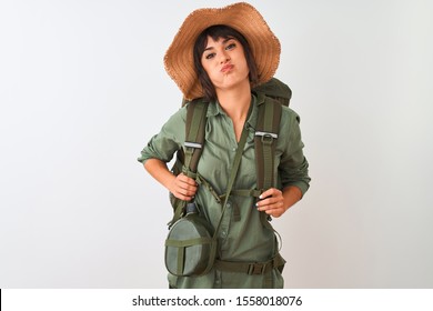 Hiker Woman Wearing Backpack Hat And Water Canteen Over Isolated White Background Puffing Cheeks With Funny Face. Mouth Inflated With Air, Crazy Expression.