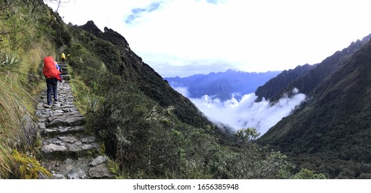 Hikers climb the difficult paths of the Inca Trail for four days long through the Sacred Valley to Machu Picchu ancient Inca city, Peru.