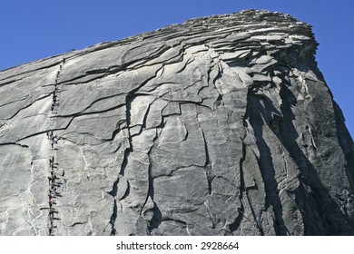 Hikers Climbing Half Dome In Yosemite National Park With An Assistance Of Cables