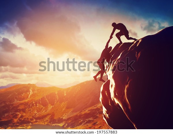 hikers-climbing-on-rock-mountain-600w-197557883.jpg