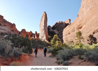 Hikers At Devil's Garden, Arches National Park In Utah, USA