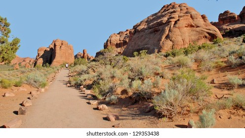 Hikers At Devil's Garden, Arches National Park In Utah, USA