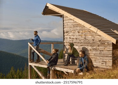 Hikers Enjoying a Peaceful Morning in the Mountains. Group of Friends Relaxing at a Scenic Mountain Cabin. Retreat concept - Powered by Shutterstock